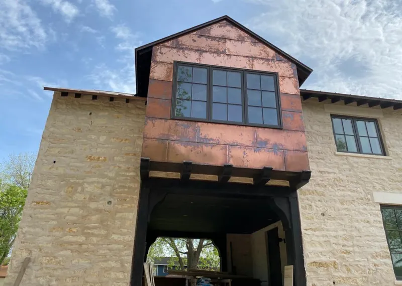 Copper metal panel facade on a stone building for Skylight Installation in North Highlands