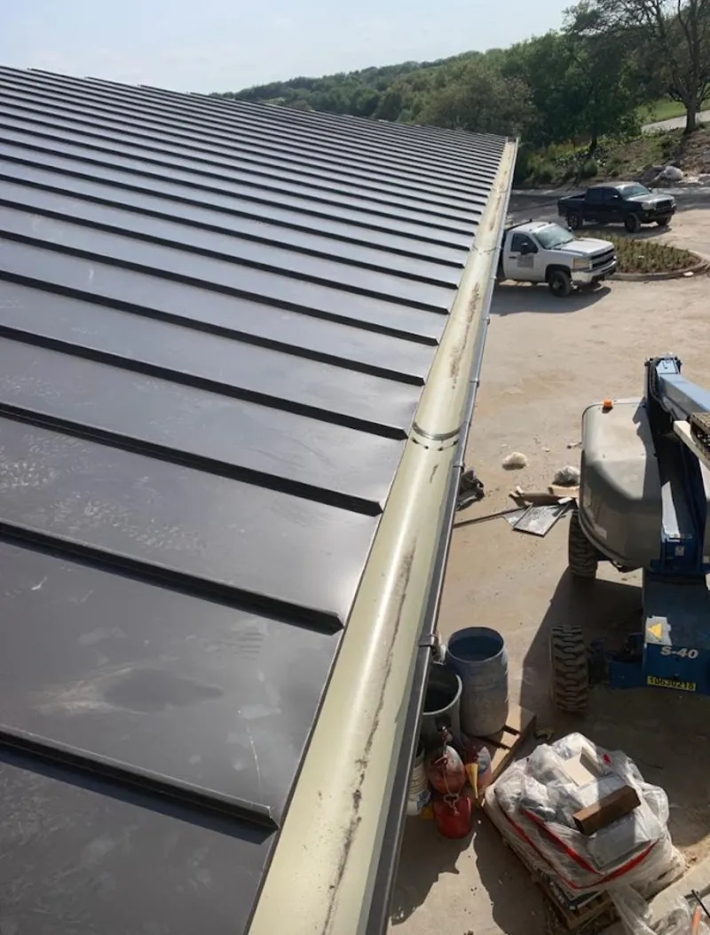 Standing seam panel and gutter detail on a metal roofing jobsite in North Highlands